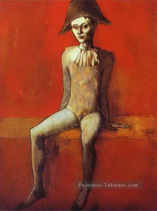 Arlequin assis sur un canapé rouge 1905 Pablo Picasso Peintures à l'huile